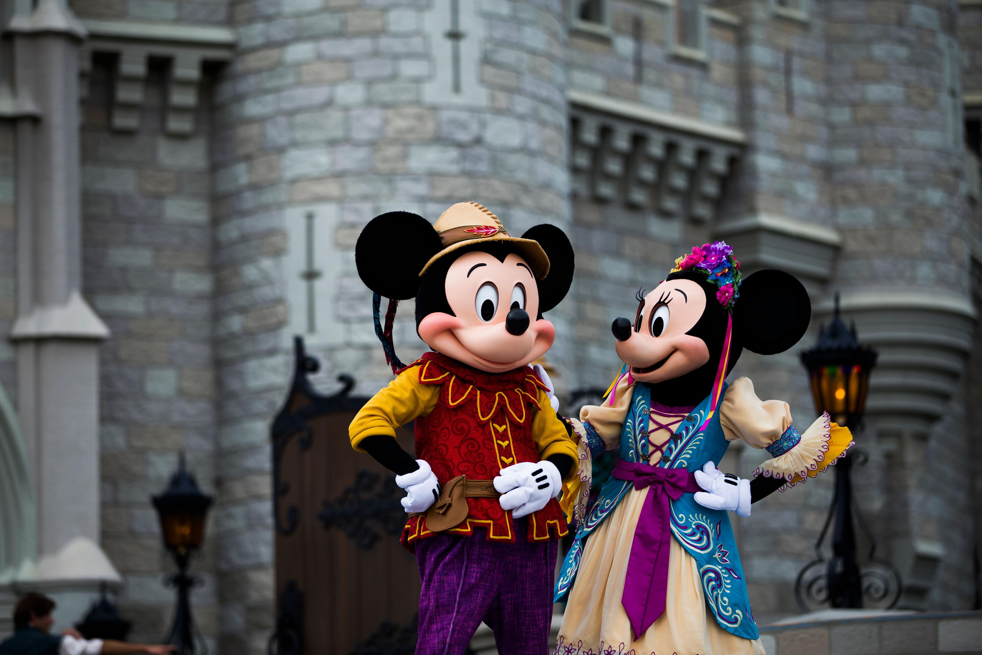 Mickey Mouse and Minnie Mouse in front of a castle